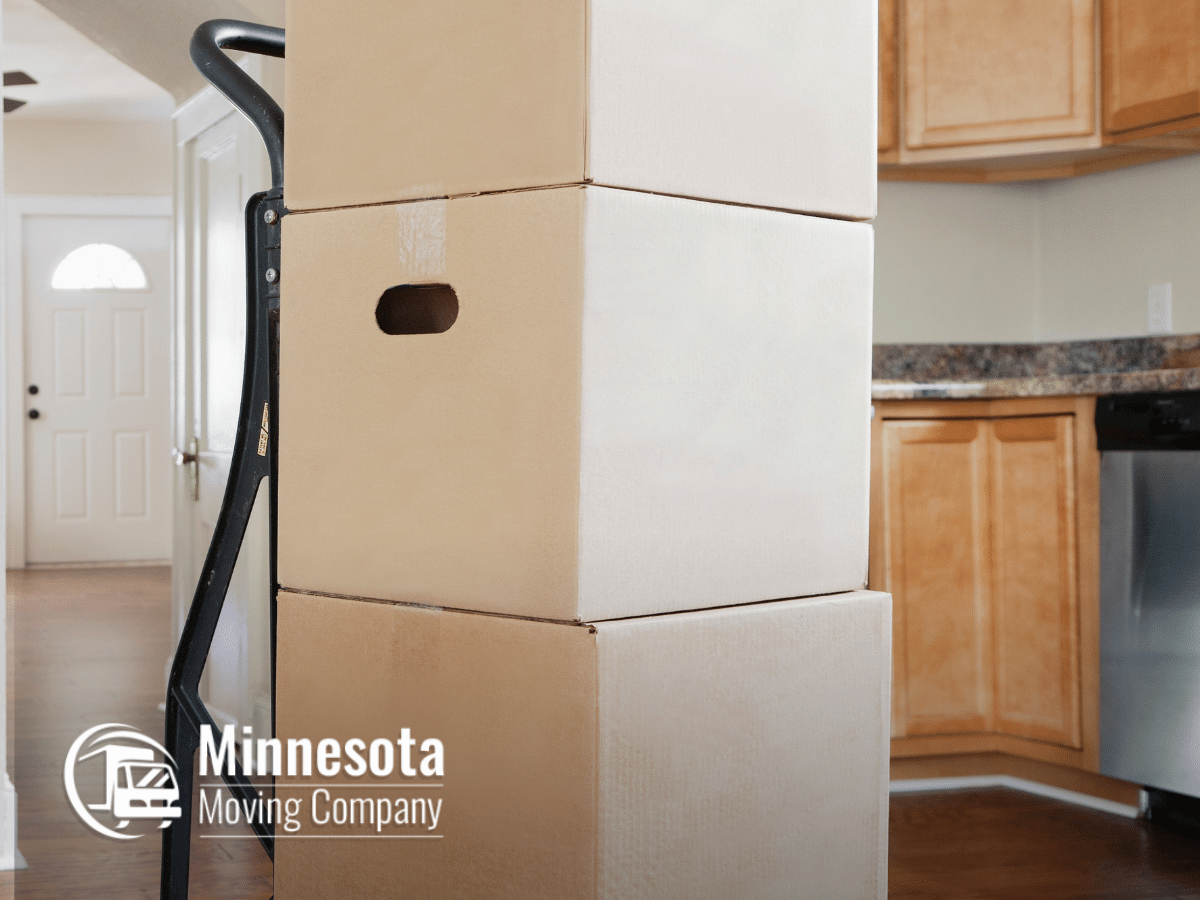 Boxes on a dolly during a residential move in a modern kitchen.